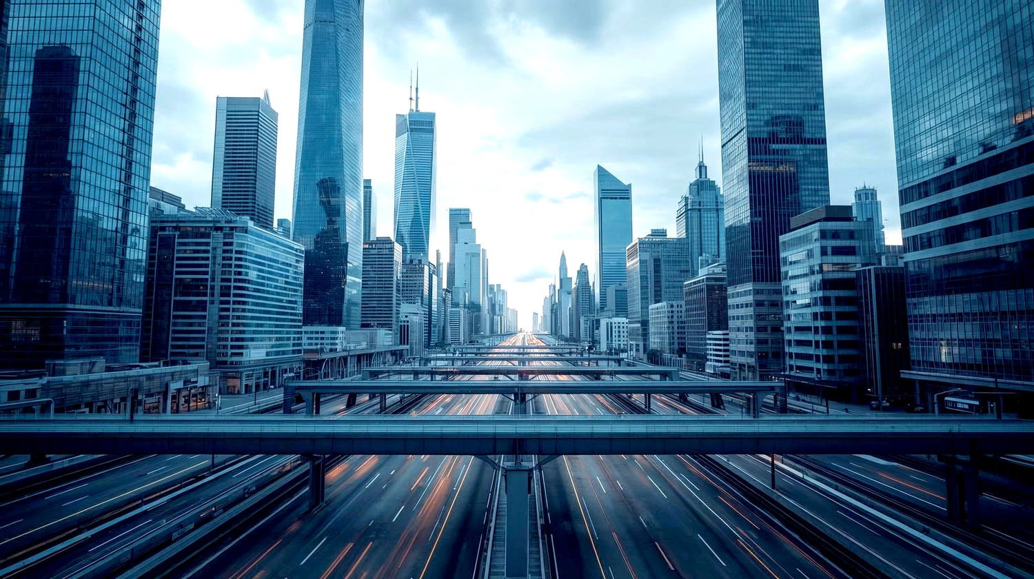 Mes West GmbH - Fachkräfte-, Investitions- und Unternehmenslösungen - Eine Weitwinkelaufnahme aus der Froschperspektive einer modernen Stadtkulisse mit gläsernen Wolkenkratzern unter einem blau getönten Himmel